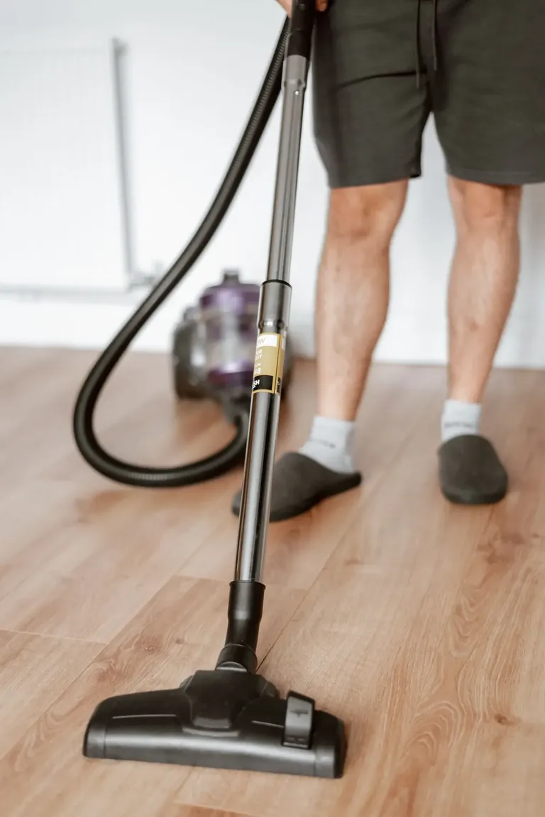 Vacuuming an empty room during a moving clean