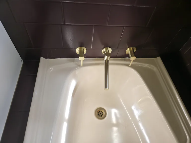 Bath and brass taps after detail cleaning at Stonefield Estate