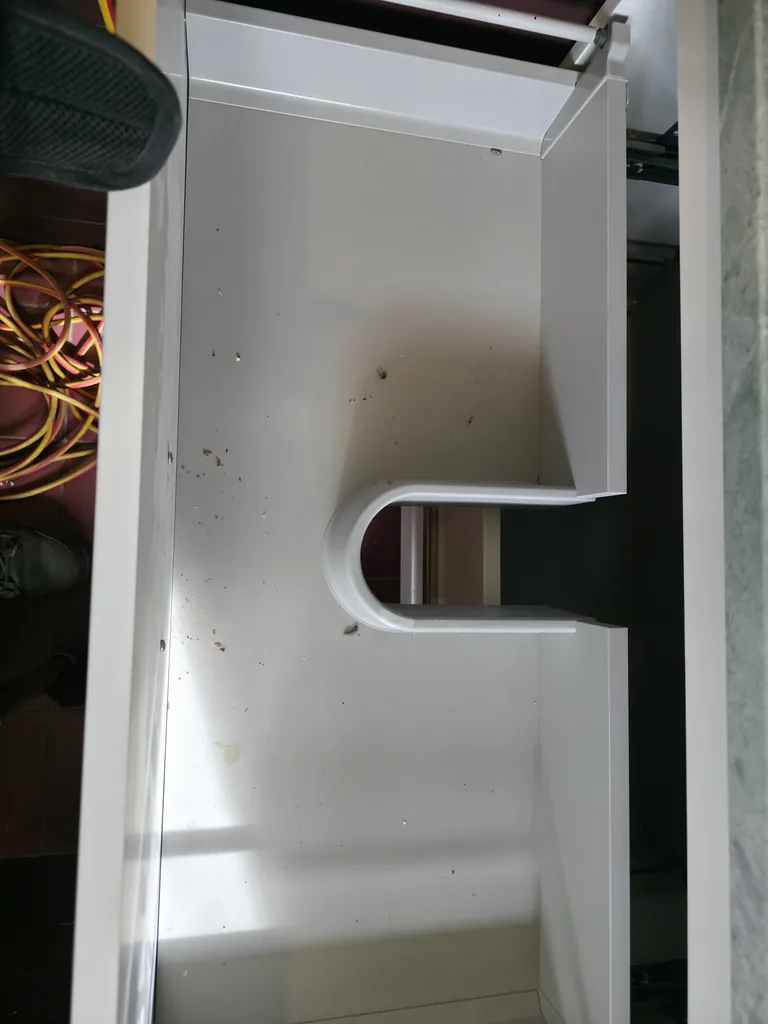 Debris in a vanity drawer before cleaning