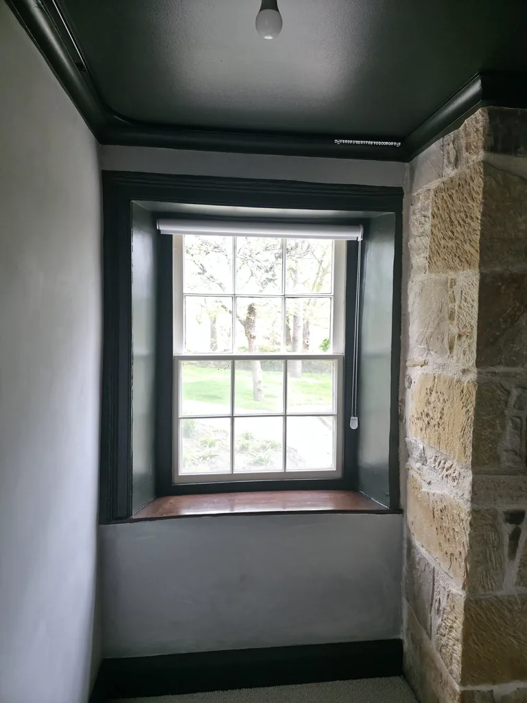 Window surround beside the sandstone fireplace
