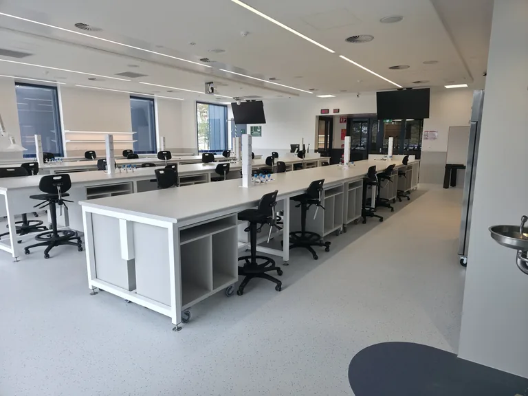 Wide view of the labs with benches, workstations and clear floor aisles