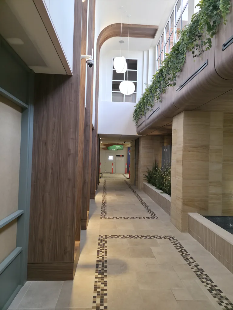 Tiled Watergarden walkway with mosaic borders, timber columns and planted features