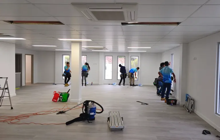 Zavvers crew cleaning floors and windows inside a commercial fit-out in Perth